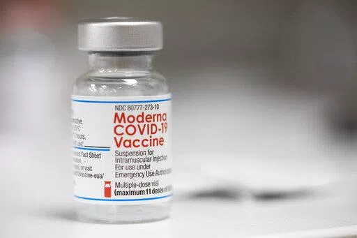 A vial of the Moderna COVID-19 vaccine is displayed on a counter at a pharmacy in Portland, Ore. on Dec. 27, 2021. A government advisory panel met Tuesday, June 14, 2022,  to decide whether to recommend a second brand of COVID-19 vaccine for school-age children and teens. The Food and Drug Administration's outside experts will vote on whether Moderna's vaccine is safe and effective enough to give kids ages 6 to 17.  If the panel endorses the shot and the FDA agrees, it would become the second op