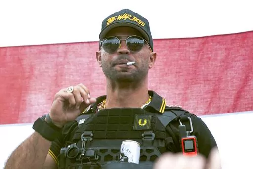 Proud Boys leader Henry "Enrique" Tarrio wears a hat that says The War Boys during a rally in Portland, Ore., Sept. 26, 2020. Federal prosecutors have rested their seditious conspiracy case against former Proud Boys leader Enrique Tarrio and four lieutenants charged with plotting to stop the peaceful transfer of presidential power from Donald Trump to Joe Biden after the 2020 election. Jurors will hear testimony by defense witnesses before they begin deliberating. (AP Photo/Allison Dinner, File)