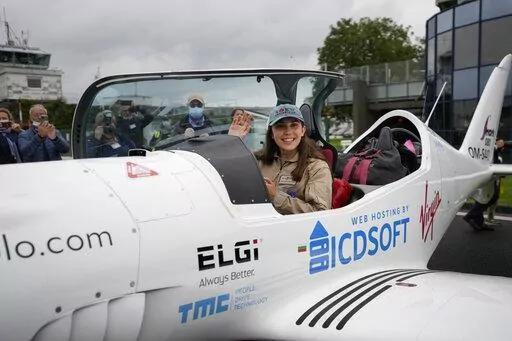 Belgian-British teenager Zara Rutherford waves from her Shark ultralight plane prior to take off at the Kortrijk-Wevelgem airfield in Wevelgem, Belgium, Aug. 18, 2021. Rutherford is set to land in Kortrijk, Belgium on Monday, Jan. 17, 2022, in the hopes of completing her trek around the world as the youngest woman ever, beating the mark of American aviator Shaesta Waiz, who was 30 when she set the previous benchmark. (AP Photo/Virginia Mayo, File)