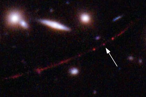 This image made available by NASA on Wednesday, March 30, 2022, shows the star Earendel, indicated by arrow, and the Sunrise Arc galaxy, stretching from lower left to upper right, optically bent due to a massive galaxy cluster between it and the Hubble Space Telescope which captured the light. The mass of the galaxy cluster serves as a magnifying glass, allowing Earendel to be seen. (NASA, ESA, Brian Welch (JHU), Dan Coe (STScI); Image processing: NASA, ESA, Alyssa Pagan (STScI) via AP)