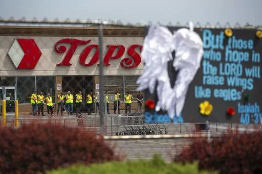 Investigators stand outside during a moment of silence for the victims of the Buffalo supermarket shooting outside the Tops Friendly Market on May 21, 2022, in Buffalo, N.Y. The number of U.S. mass killings linked to extremism was at least three times higher in the last decade than the total from any 10-year period since the 1970s. That's according to a report released to The Associated Press by the Anti-Defamation League. (AP Photo/Joshua Bessex, File)