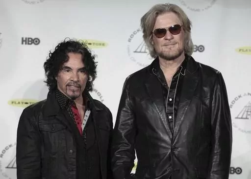 Hall of Fame Inductees John Oates, left, and Daryl Hall appear in the press room at the Rock and Roll Hall of Fame Induction Ceremony on April, 10, 2014, in New York. After more than a half-century of making music together, Hall is suing Oates over a proposed sale of his share of a Hall & Oates business partnership that Hall says he hasn't approved. A Nashville judge recently paused the sale of Oates' stake in Whole Oats Enterprises LLP to Primary Wave IP Investment Management LLC pending arbitr