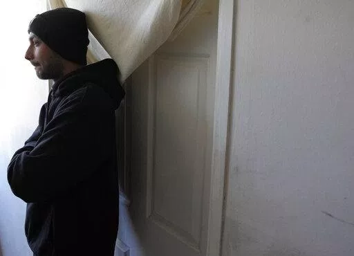 Hasib Qarizada a student from Afghanistan stands outside his room in the "Krnjaca" refugee centre near Belgrade, Serbia, Thursday, Feb. 24, 2022. While tens of thousands of refugees from Ukraine have found safety and help in Hungary, thousands of others weren't so lucky. Among them was Hasib Qarizada, a 25-year-old student from Afghanistan. He had been studying in Hungary for years butwas expelled last September even as his native country unraveled. (AP Photo/Darko Vojinovic)