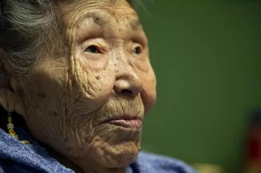 Lizzie Chimiugak looks on at her home on Monday, Jan. 20, 2020, in Toksook Bay, Alaska. Chimiugak, who turned 90 years old on Monday, is scheduled to be the first person counted in the 2020 U.S. Census on Tuesday. The share of seniors age 65 or older in the U.S. grew by more than a third, while the share of children declined, particularly among those under age 5, according to new figures from the 2020 census released Thursday, May 25, 2023. (AP Photo/Gregory Bull, File)