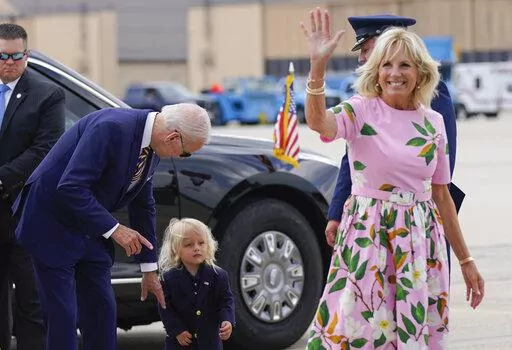 President Joe Biden looks at his grandson Beau Biden as first lady Jill Biden waves and walks to board Air Force One at Andrews Air Force Base, Md., Aug. 10, 2022. First lady Jill Biden tested positive for COVID-19 and is experiencing ‘mild symptoms’ the White House announced Tuesday. (AP Photo/Manuel Balce Ceneta, File)