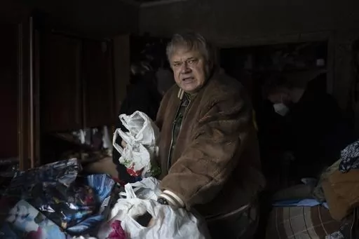 Serhii Slobodiannyk, 63, stands inside of his apartment that was damaged as a result of Russia's attack on Jan. 2 in Kyiv, Ukraine, Wednesday, Jan. 3, 2024. "Everything I worked for over 30 years was destroyed in less than a second," he says. (AP Photo/Hanna Arhirova)