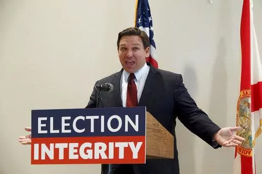 Florida Gov. Ron DeSantis asks the crowd "How about Virginia," as he arrives at an event in West Palm Beach, Fla., to announce proposed election reform laws, Wednesday, Nov. 3, 2021.  Republicans promoting claims of widespread voter fraud in at least two politically important states are turning to a new tactic to appease voters who falsely believe the 2020 presidential election was stolen: election police. The efforts in Florida and Georgia to establish law enforcement units dedicated to investi