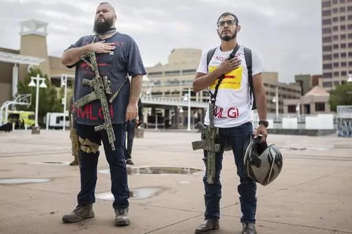 Demonstrators carry their assault rifles to a Second Amendment rally in response to Gov. Michelle Lujan Grisham's recent public health order suspending the conceal and open carry of guns in and around Albuquerque for 30-days, Tuesday, Sept. 12, 2023, in Albuquerque, N.M. Restrictions on carrying guns in public that are tied to an emergency public health order are going under the legal microscope Tuesday, Oct. 3, in New Mexico, where the Democratic governor is testing the boundaries of her author