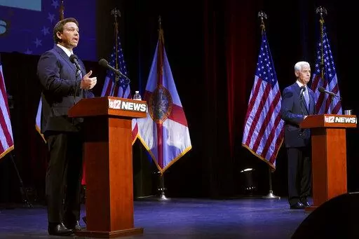 Florida's Republican Gov. Ron DeSantis, left, speaks during a debate with his Democratic opponent Charlie Crist in Fort Pierce, Fla., Monday, Oct. 24, 2022. (Crystal Vander Weit/TCPalm.com via AP, Pool)