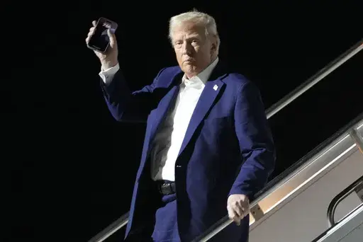 President Donald Trump arrives on Air Force One at Harry Reid International Airport in Las Vegas, Friday, Jan. 24, 2025. (AP Photo/Mark Schiefelbein)