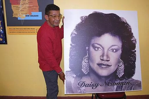 Bobby Dennis, executive director of the Natchez Museum of African American History and Culture holds a portrait of opera singer and music educator Daisy Cecelia Newman, who was born in the state and had an international performing career that included a nomination for a Tony award, Thursday, Dec. 30, 2021, in Natchez, Miss. Newman's portrait will be included in "The Black Butterfly," an exhibition about her life at the museum. (Roscoe Barnes III/The Natchez Democrat via AP)
