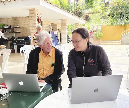 In this undated photo provided by Massachusetts General Hospital, Dr. Francisco Lopera, right, of the University of Antioquia, a neurologist who has spent decades caring for a large Colombian family plagued by early-in-life Alzheimer’s, confers with fellow researcher Yakeel Quiroz of Massachusetts General Hospital. (Massachusetts General Hospital via AP)