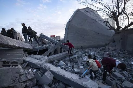 Palestinians look at a mosque destroyed in an Israeli strike in Rafah, Gaza Strip, Wednesday, Jan. 24, 2024. Efforts to reach a new cease-fire between Israel and Hamas appear to be gaining steam. Any deal would have to include a pause in fighting, an exchange of hostages held by Hamas for Palestinian prisoners held by Israel and large quantities of desperately needed humanitarian assistance for the war-battered Gaza Strip. But finding a formula acceptable to both sides has been elusive. The gaps