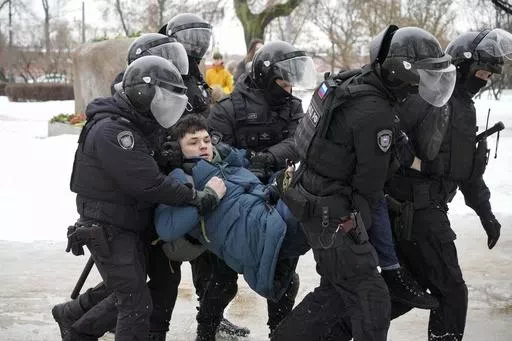Police detain a man trying to lay flowers to honor Alexei Navalny at a monument in St. Petersburg, Russia, to victims of Soviet repression, on Saturday, Feb. 17, 2024. Over the last decade, Vladimir Putin's Russia evolved from a country that tolerates at least some dissent to one that ruthlessly suppresses it. Arrests, trials and long prison terms — once rare — are commonplace. (AP Photo, File)
