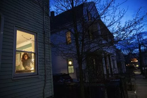McKenna Shuster works on a linocut art print which she does as a hobby in her home on the last night of a two-week self-isolation while recovering from symptoms of COVID-19 in Somerville, Mass., on March 26, 2020. On Friday, March 1, 2024, the Centers for Disease Control and Prevention said people who test positive for COVID-19 no longer need to stay in isolation for five days. The CDC changed its longstanding guidance, saying that people can return to work or regular activities if their symptom