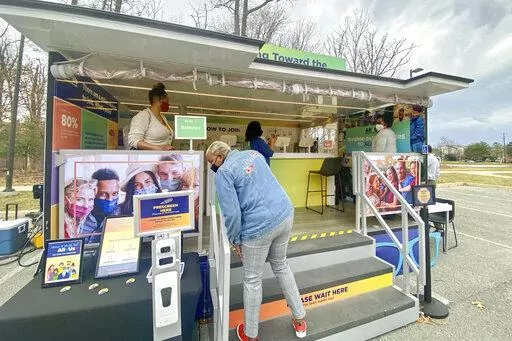 In this photo provided by the National Institute of Health's "All of Us" research program, people visit a study vehicle in Silver Spring, Md. on March 8, 2022. The study aims to eventually enroll a million Americans from all walks of life in a genomic database, part of a quest to reduce health disparities and offer care that's more tailored than today's one-size-fits-all approach. (Dianne Beltran/All of Us Research Program via AP)