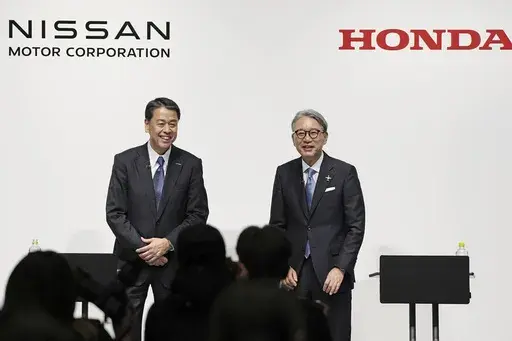 Nissan Chief Executive Makoto Uchida, left, and Honda President Toshihiro Mibe attend a joint news conference in Tokyo, Friday, March 15, 2024. (Kyodo News via AP, File)