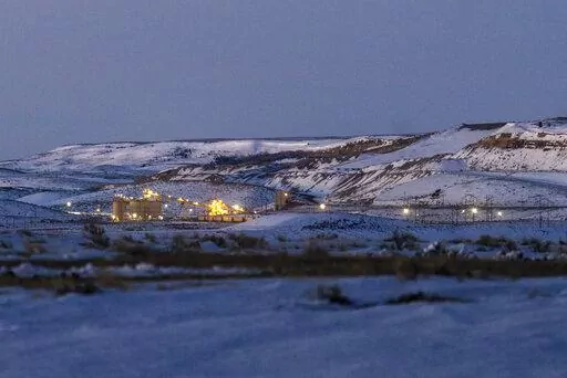 Lights illuminate a coal mine at twilight, Jan. 13, 2022, in Kemmerer, Wyo. With the nearby coal-fired Naughton Powerplant being decommissioned in 2025, the fate of the coal mine and its workers is uncertain. More than 500 days into his presidency, Joe Biden's hope for saving the Earth from the most devastating effects of climate change may not be dead. But it's not far from it after a Supreme Court ruling not only limited the Environmental Protection Agency's ability to regulate pollution by po