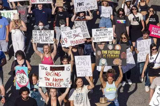 Hundreds of demonstrators rally and march in opposition to the U.S. Supreme Court's decision overturning Roe v. Wade in downtown Raleigh, N.C., on June, 24, 2022. Abortions in North Carolina are no longer legal after 20 weeks of pregnancy, a federal judge ruled Wednesday, Aug. 17, 2022 eroding protections in one of the South’s few remaining safe havens for reproductive freedom. (Travis Long/The News & Observer via AP, File)