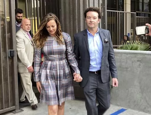 Actor Danny Masterson leaves Los Angeles superior Court with his wife Bijou Phillips after a judge declared a mistrial in his rape case in Los Angeles on Nov. 30, 2022. Masterson is going back on trial on three charges of rape. A deadlocked jury led to a mistrial for Masterson in November. Opening statements in his retrial will begin on Monday. (AP Photo/Brian Melley, File)