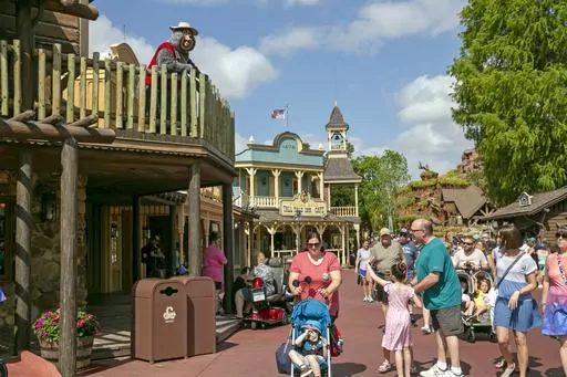 A performer dressed as a bear from the Country Bear Jamboree show entertains visitors from a deck at Magic Kingdom Park at Walt Disney World Resort in Lake Buena Vista, Florida, on April 22, 2022. It wasn't an escapee from the Country Bear Jamboree attraction, but a wild black bear managed to be the star of its own show Monday Sept. 18 2023 at Walt Disney World. The presence of the black bear in a tree in the Magic Kingdom delayed the opening of three lands Monday morning — Frontierland, Liber