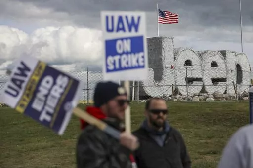 Striking UAW workers picket at the Jeep Assembly Plant on Oct. 9, 2023 in Toledo, Ohio. The UAW contends that the furloughs by Detroit's three automakers were not necessary and are being done in an effort to push members to accept less in contract negotiations. (Jonathan Aguilar/The Blade via AP, File)