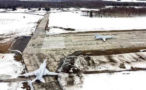 In this photo taken from video and released by the Russian Defense Ministry Press Service on Saturday, Feb. 5, 2022, A pair of Tu-22M3 bombers of the Russian air force taxi before takeoff at an air base in Russia. Two Tu-22M3 long-range bombers of the Russian air force performed a patrol mission over Belarus on Saturday amid the tensions over Ukraine. (Russian Defense Ministry Press Service via AP)
