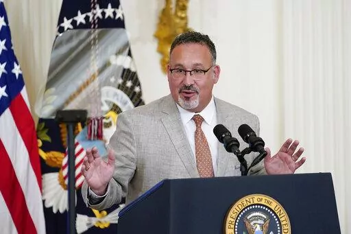 Education Secretary Miguel Cardona speaks during the 2022 National and State Teachers of the Year event in the East Room of the White House in Washington, April 27, 2022. The Biden administration says it will forgive all remaining federal student debt for former students of the for-profit Corinthian Colleges chain. “As of today, every student deceived, defrauded and driven into debt by Corinthian Colleges can rest assured that the Biden-Harris Administration has their back and will discharge t