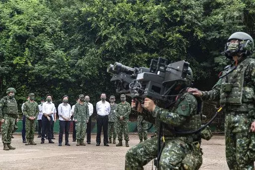 In this photo released by the Taiwan Ministry of National Defense, Taiwan's President Tsai Ing-wen watches soldiers operate equipment during a visit to a naval station on Penghu, an archipelago of several dozen islands off Taiwan's western coast on Tuesday, Aug. 30, 2022. Tsai told the self-ruled island's military units Tuesday to keep their cool in the face of daily warplane flights and warship maneuvers by rival China, saying that Taiwan will not allow Beijing to provoke a conflict. visit to 