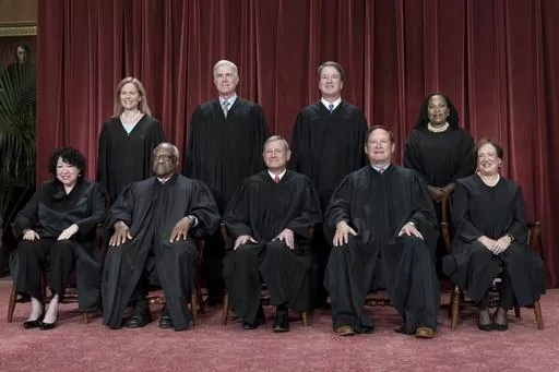 Members of the Supreme Court sit for a new group portrait following the addition of Associate Justice Ketanji Brown Jackson, at the Supreme Court building in Washington, Oct. 7, 2022. Bottom row, from left, Justice Sonia Sotomayor, Justice Clarence Thomas, Chief Justice John Roberts, Justice Samuel Alito, and Justice Elena Kagan. Top row, from left, Justice Amy Coney Barrett, Justice Neil Gorsuch, Justice Brett Kavanaugh, and Justice Ketanji Brown Jackson. The Supreme Court is adopting its first