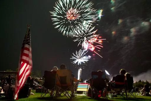 Spectators watch as fireworks explode overhead during the Fourth of July celebration at Pioneer Park, on July 4, 2013, in Prescott, Ariz. The skies over a scattering of Western cities will stay dark for the third consecutive Fourth of July in 2022 as some big fireworks displays are canceled again, this time for pandemic related supply chain or staffing problems, or fire concerns amid dry weather. The city of Phoenix cited supply chain issues in canceling its three major Independence Day firework