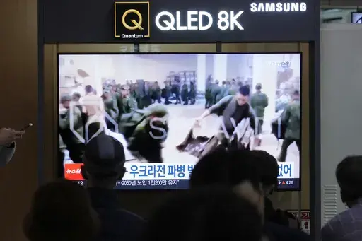 A TV screen shows an image of soldiers believed to be from North Korea stand in line to receive supplies from Russia during a news program at Seoul Railway Station in Seoul, South Korea, on Oct. 21, 2024. (AP Photo/Ahn Young-joon, File)