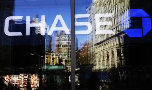 A Chase bank branch is seen through glass on Jan. 11, 2016, in New York. An unexplained outage at Chase Bank Tuesday, July 25, 2023, has led to interruptions for users of the Zelle payment network, who took to social media to complain. (AP Photo/Mark Lennihan, File)
