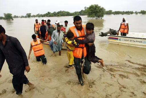 Army troops evacuate people from a flood-hit area in Rajanpur, district of Punjab, Pakistan, Aug. 27, 2022. Loss and damage is the human side of a contentious issue that will likely dominate climate negotiations in Egypt. Extreme weather is worsening as the world warms, with a study calculating that human-caused climate change increased Pakistan’s flood-causing rain by up to 50%. (AP Photo/Asim Tanveer, File)