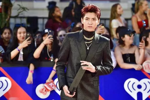 Singer Kris Wu celebrates his award for Fan Fave New Artist on the red carpet at the iHeartRadio MMVAs in Toronto on Aug. 26, 2018. A Beijing court on Friday, Nov. 25, 2022 sentenced Chinese-Canadian pop star Kris Wu to 13 years in prison on charges including rape. (Frank Gunn/The Canadian Press via AP, File)