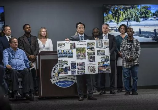 Sacramento County District Attorney Thien Ho holds a poster collage titled "criminal behavior" as he announces on Tuesday, Sept. 19, 2023, that his office is suing the city of Sacramento for creating a public nuisance by failing to take stronger action on homeless camps. A Sacramento prosecutor is suing California's capital city over failure to clean up homeless encampments. Sacramento District Attorney Thien Ho says his office asked the city to enforce laws around sidewalk obstruction and to cr