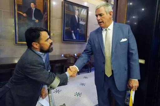 As is his tradition, House Speaker Philip Gunn, R-Clinton, right, shakes the hand and says goodbye to each lawmaker, such as Rep. Shane Aguirre, R-Tupelo, at the conclusion of the legislative session at the Mississippi Capitol in Jackson, Tuesday, April 5, 2022. (AP Photo/Rogelio V. Solis)