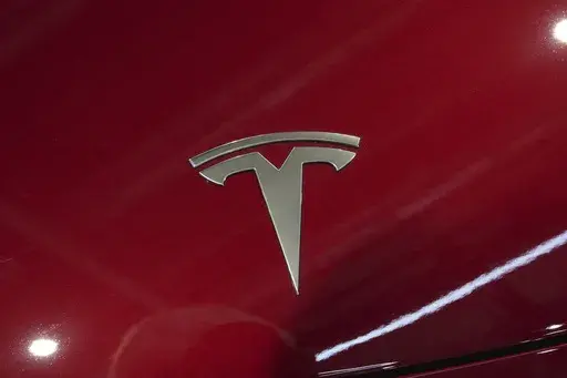 The logo of Tesla car is pictured at the Paris Auto Show, in Paris, Oct. 14, 2024. (AP Photo/Michel Euler, File)