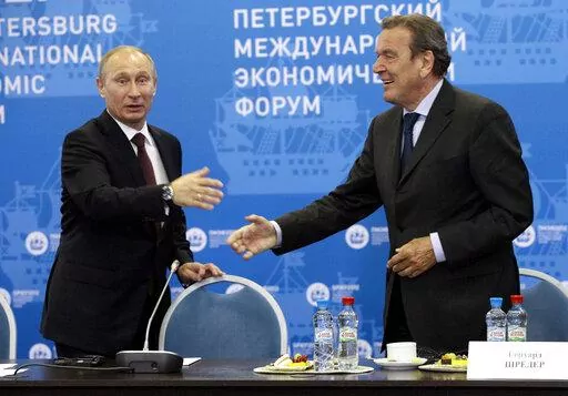 Russian President Vladimir Putin, left, and Germany's former Chancellor Gerhard Schroeder attend an economic forum in St.Petersburg, Russia, Thursday, June 21, 2012. Gerhard Schroeder left the German chancellery after a narrow election defeat in 2005 with an ambitious overhaul of the country’s welfare state beginning to kick in and every chance of becoming a respected elder statesman. Fast-forward to last week: German lawmakers agreed to shut down Schroeder’s taxpayer-funded office, the Euro