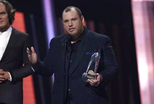 Luke Combs accepts the award for entertainer of the year during the 56th Annual CMA Awards on Wednesday, Nov. 9, 2022, at the Bridgestone Arena in Nashville, Tenn. (AP Photo/Mark Humphrey)