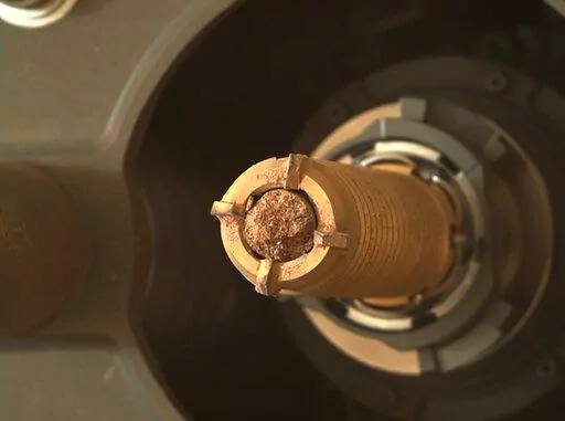 This photo provided by NASA shows a rock collected by the Perseverance rover on Mars. NASA is launching two more mini helicopters to Mars in its effort to recover Martian rocks and soil samples and bring them to Earth.
Under the plan announced Wednesday, July 27, 2022,   NASA’s Perseverance rover will do double duty and transport samples to the rocket that will launch them off Mars a decade from now.
Perseverance already has gathered 11 samples, with about 30 more to go. The most recent samp