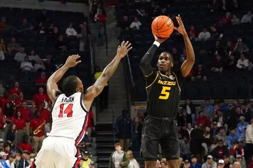 Missouri guard D'Moi Hodge (5) shoots a 3-pointer over Mississippi guard Tye Fagan (14) during the first half of an NCAA college basketball game in Oxford, Miss., Tuesday, Jan. 24, 2023. (AP Photo/Rogelio V. Solis)
