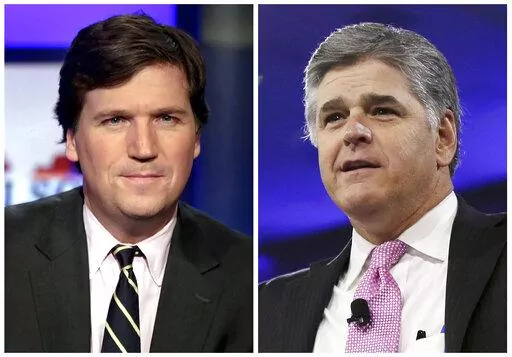 This combination photo shows, from left, Tucker Carlson, host of "Tucker Carlson Tonight," and Sean Hannity, host of "Hannity" on Fox News. Several conservative media figures in the United States, including Carlson and Hannity, have taken up the cause of Canadian truckers who have occupied parts of Ottawa and blocked border crossings to protest COVID-19 restrictions and vaccine mandates. (AP Photo/File)
