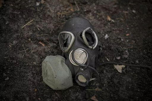 A damaged gas mask lies on the pavement at a Russian position which was overran by Ukrainian forces, outside Kyiv, Ukraine, March 31, 2022. Russia’s assault on Ukraine and its veiled threats of using nuclear arms have policymakers questioning how the West should respond to a Russian battlefield explosion of a nuclear bomb. The default U.S. policy answer, say some architects of the post-Cold War nuclear order, is with discipline and restraint. (AP Photo/Vadim Ghirda, File)