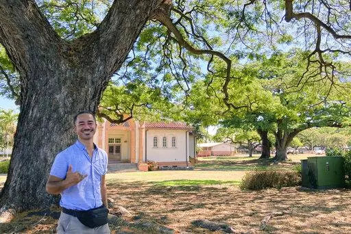 Sautia Tanoa poses for a photo while visiting his former high school in Honolulu on Friday, July 29, 2022. Tanoa is among the McKinley High School graduates who want to see the name restored to Honolulu High School out of respect for Hawaiian culture and history. Some alumni say changing the name would rattle their identity. (AP Photo/Jennifer Sinco Kelleher)