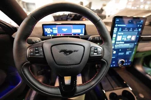 The cockpit of a Ford Mustang Mach-E electric car is pictured at the Motor Show in Essen, Germany, Thursday, Dec. 2, 2021 (AP Photo/Martin Meissner)