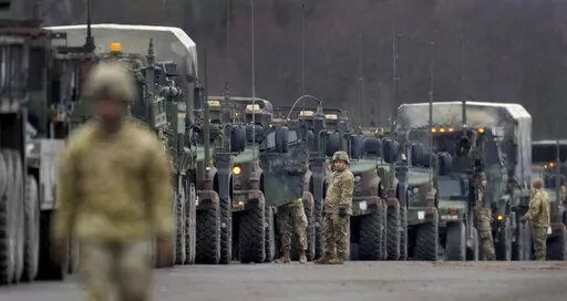 Soldiers of the 2nd Cavalry Regiment line up vehicles at the military airfield in Vilseck, Germany, Wednesday, Feb. 9, 2022 as they prepare for the regiment's movement to Romania loading of Stryker combat vehicles for their deployment to support NATO allies and demonstrate U.S. commitment to NATO Article V. The soldiers will deploy to Romania in the coming days from their post in Vilseck and will augment the more than 900 U.S. service members already in Romania. This Stryker Squadron represents 