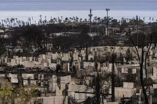 A general view shows the aftermath of a wildfire in Lahaina, Hawaii, Monday, Aug. 21, 2023. The wildfires devastated parts of the Hawaiian island of Maui earlier this month. Maui County is suing major cellular carriers for failing to properly inform police of widespread service outages during the height of last summer's deadly wildfire. (AP Photo/Jae C. Hong, File)