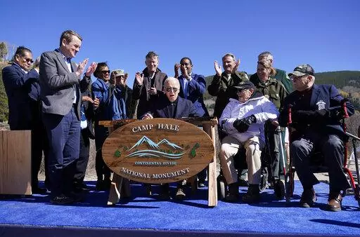 President Joe Biden reacts after signing a proclamation to designate the first national monument of his administration at Camp Hale, a World War II-era training site, near Leadville, Colo., Wednesday, Oct. 12, 2022. The location is an alpine training site where U.S. soldiers prepared for battles in the Italian Alps during World War II. (AP Photo/Carolyn Kaster)
