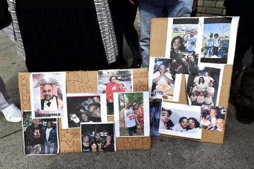 Photographs of De'vazia Turner are on display as his mother Penelope Scott speaks to the media during an interview at the corner of 10th and K street in Sacramento, Calif., on Monday, April 4, 2022. Turner was shot and killed after a shooting broke out early Sunday morning. Multiple people were killed and injured in the shooting.  (Jose Carlos Fajardo/Bay Area News Group via AP)